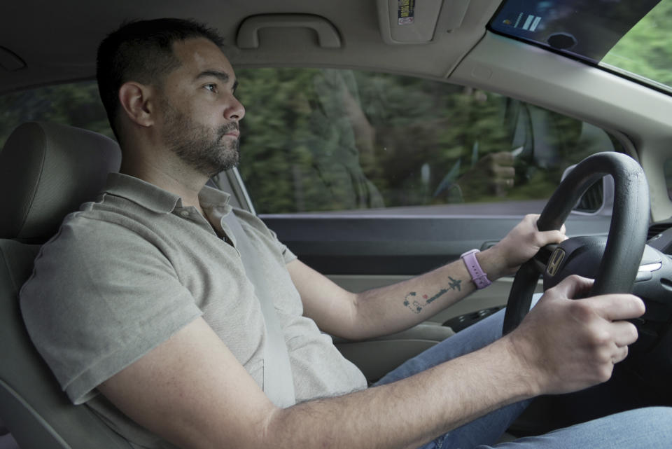 Fernando Hermida drives to Orlando, Fla., to attend a medical appointment for HIV care on May 27, 2024. He never imagined getting medication would be so difficult, he said during the 500-mile drive from North Carolina to Florida. (AP Photo/Laura Bargfeld)