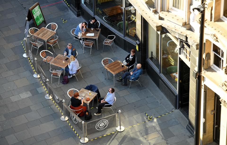 Customers sit outside bar in NewcastleAFP via Getty Images