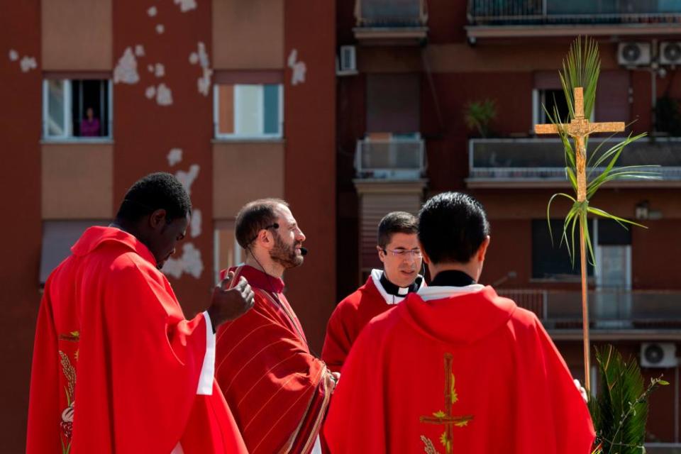 Parish priest Don Antonio Lauri celebrates Palm Sunday mass from the rooftop of the St Gabriel of Sorrows church in Rome.