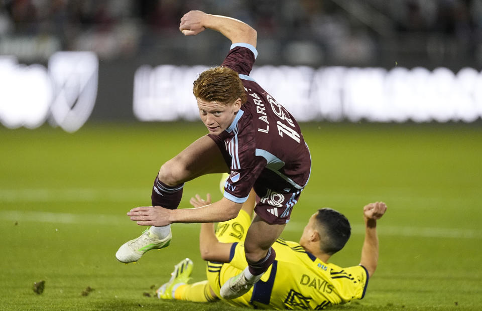 Colorado Rapids midfielder Oliver Larraz, top, is tripped by Nashville SC midfielder Sean Davis, bottom, during the first half of an MLS soccer match Saturday, March 2, 2024, in Commerce City, Colo. (AP Photo/David Zalubowski)