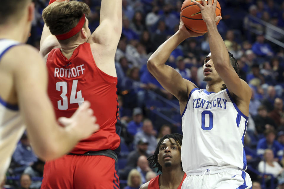 Kentucky's Jacob Toppin (0) shoots while defended by Duquesne's Austin Rotroff (34) during the second half of an NCAA college basketball game in Lexington, Ky., Friday, Nov. 11, 2022. (AP Photo/James Crisp)