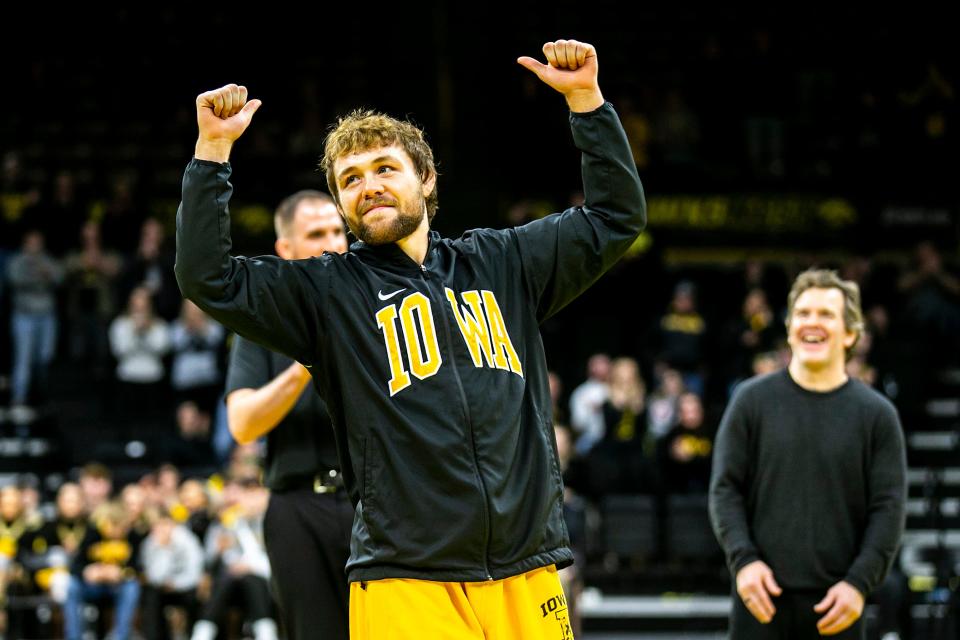 Iowa's Jacob Warner waves to fans as he is acknowledged on senior day after a NCAA college men's wrestling dual against Oklahoma State, Sunday, Feb. 19, 2023, at Carver-Hawkeye Arena in Iowa City, Iowa.