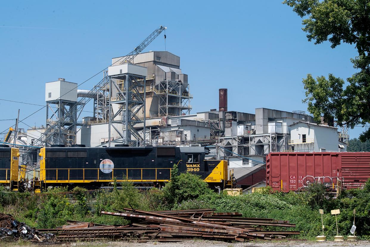 The Canton mill's smokestacks are being disassembled with the help of a crane on Aug. 23, 2023.