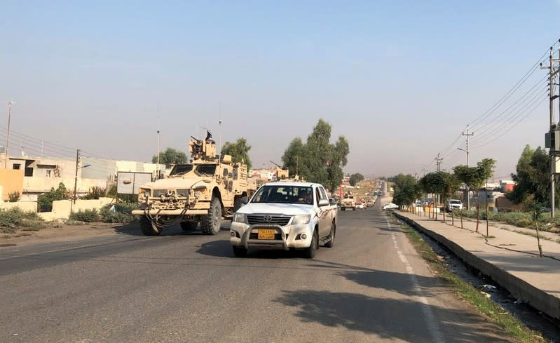 A convoy of U.S. vehicles are seen after withdrawing from northern Syria, at the Iraqi-Syrian border crossing in the Sahela