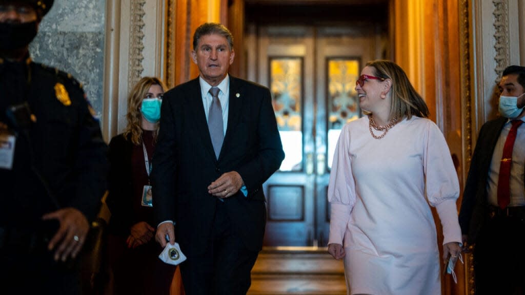 Sen. Joe Manchin (D-WV) leaves the Senate Chamber with Sen. Kyrsten Sinema (D-AZ) following a vote in the Senate at the U.S. Capitol Building on Wednesday, Nov. 3, 2021 in Washington, DC. Senate Republicans blocked debate on the John R. Lewis Voting Rights Advancement Act. (Kent Nishimura / Los Angeles Times via Getty Images)