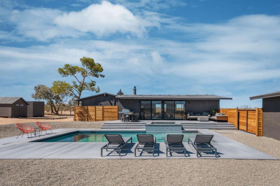 Black Rock Homestead in Joshua Tree, a modern black home with minimal warm interiors