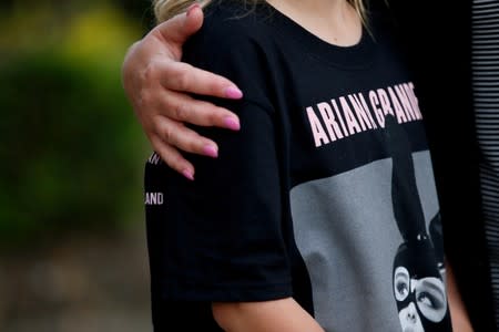 FILE PHOTO: A youngster wearing a t-shirt showing U.S. singer Ariana Grande talks to the media near the Manchester Arena in Manchester