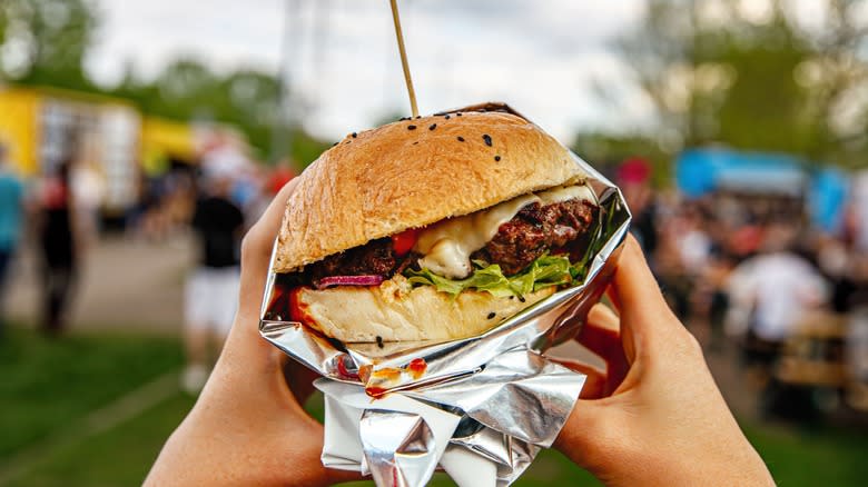 Hands holding street food sandwich