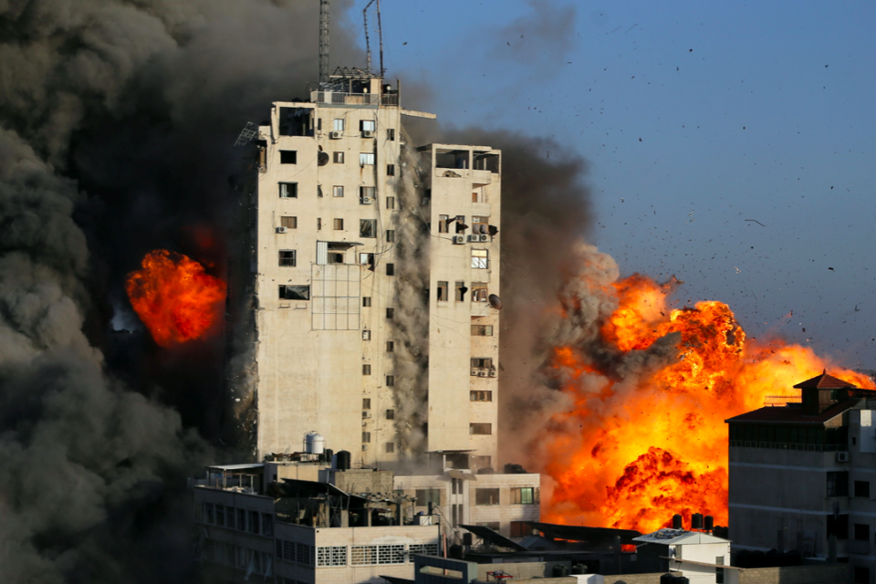 Smoke and flames rise from a tower building as it is destroyed by Israeli air strikes amid a flare-up of Israeli-Palestinian violence in Gaza City. (Reuters/Ibraheem Abu Mustafa)