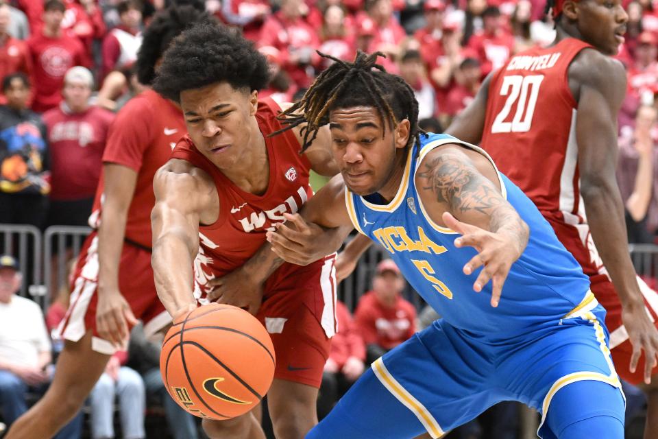 Washington State forward Jaylen Wells (0) deflects a pass intended for UCLA guard Brandon Williams (5) in the first half on March 2.