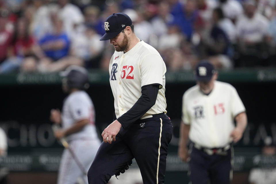 Texas Rangers starting pitcher Jordan Montgomery (52) walks onto the mound as manager Bruce Bochy, right rear, walks out to pull him in the fourth inning of a baseball game against the Minnesota Twins, Saturday, Sept. 2, 2023, in Arlington, Texas. (AP Photo/Tony Gutierrez)