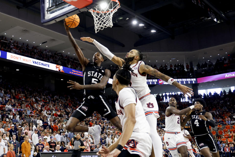 Mississippi State guard Shawn Jones Jr. (5) lays in a basket as Auburn forward Johni Broome (4) defends during the first half of an NCAA college basketball game, Saturday, March 2, 2024, in Auburn, Ala. (AP Photo/ Butch Dill)