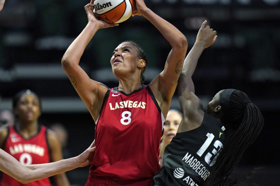 Las Vegas Aces' Liz Cambage (8) shoots over Seattle Storm's Ezi Magbegor in the first half of a WNBA basketball game Saturday, May 15, 2021, in Everett, Wash. (AP Photo/Elaine Thompson)