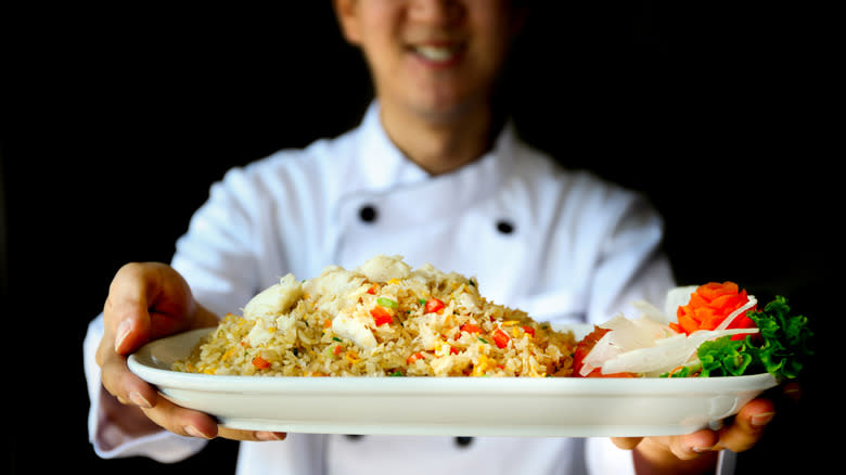 chef holding fried rice plate