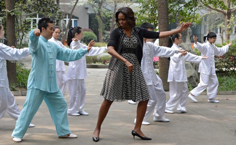 US First Lady Michelle Obama (C) performs "tai chi" with students from the Chengdu No7 High School in Chengdu in China's southwest Sichuan province on March 25, 2014