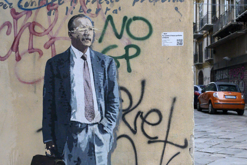 The mural of anti-Mafia prosecutor Paolo Borsellino created by street artist TvBoy and damaged by unknown persons in August is seen in Palermo, Italy, Tuesday Jan. 17, 2023. Italy's No. 1 fugitive, Mafia boss Matteo Messina Denaro, was arrested Monday after 30 years on the run. He is set to be imprisoned for the two bombings in Sicily in 1992 that murdered the two top anti-Mafia prosecutors Giovanni Falcone and Paolo Borsellino, and other grisly crimes. (AP Photo/Valeria Ferraro)