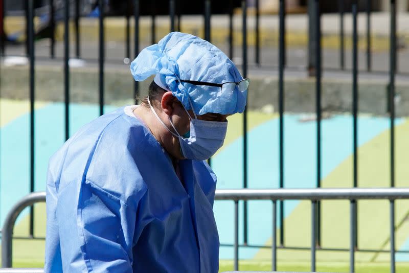 Healthcare worker in PPE walks outside Elmhurst Hospital during outbreak of coronavirus disease (COVID-19) in New York