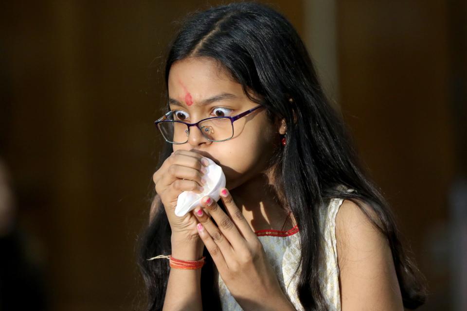 Anya Singh, 11, of Fair Lawn, blows a sankha, or a conch, during Durga Puja celebrations at Sharadotsav 2022, in Bergenfield. Sunday, October 2, 2022