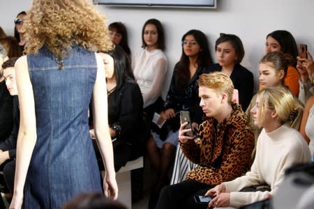 Members of the public watch models present creations at the Alexa Chung public catwalk show during London Fashion Week in London