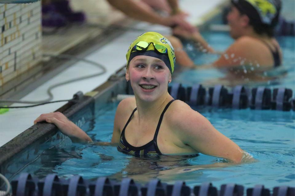 Delta girls swimming freshman Elle Groves reacts to breaking the 200yd freestyle school record (1:59.67) in the team's meet at Delta High School on Monday, Dec. 5, 2022.
