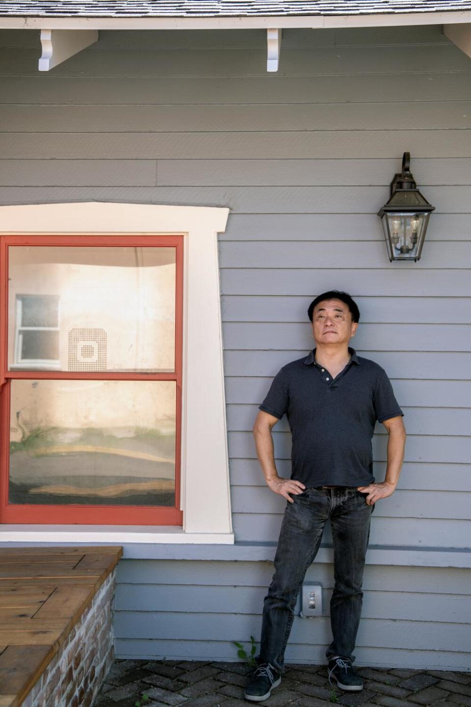 Architect Jingbo Lou in front of one of the converted Craftsman bungalows at Alpine Courtyard.