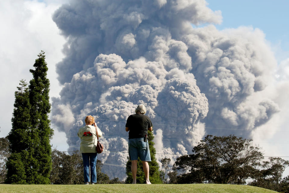 People watch ash erupt from the Halema'uma'u Crater on Saturday.