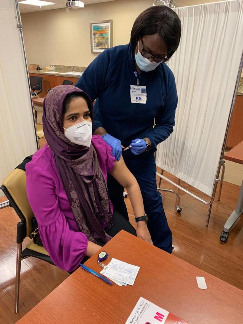 Tehsin Siddiqui, member of the Coalition of South Florida Muslim Organizations, gets her vaccine at Jackson South. Siddiqui helped organize vaccines through the Islamic Center of Greater Miami for about 25 people, some from the NUR Center, the domestic violence shelter in South Florida for Muslim women.