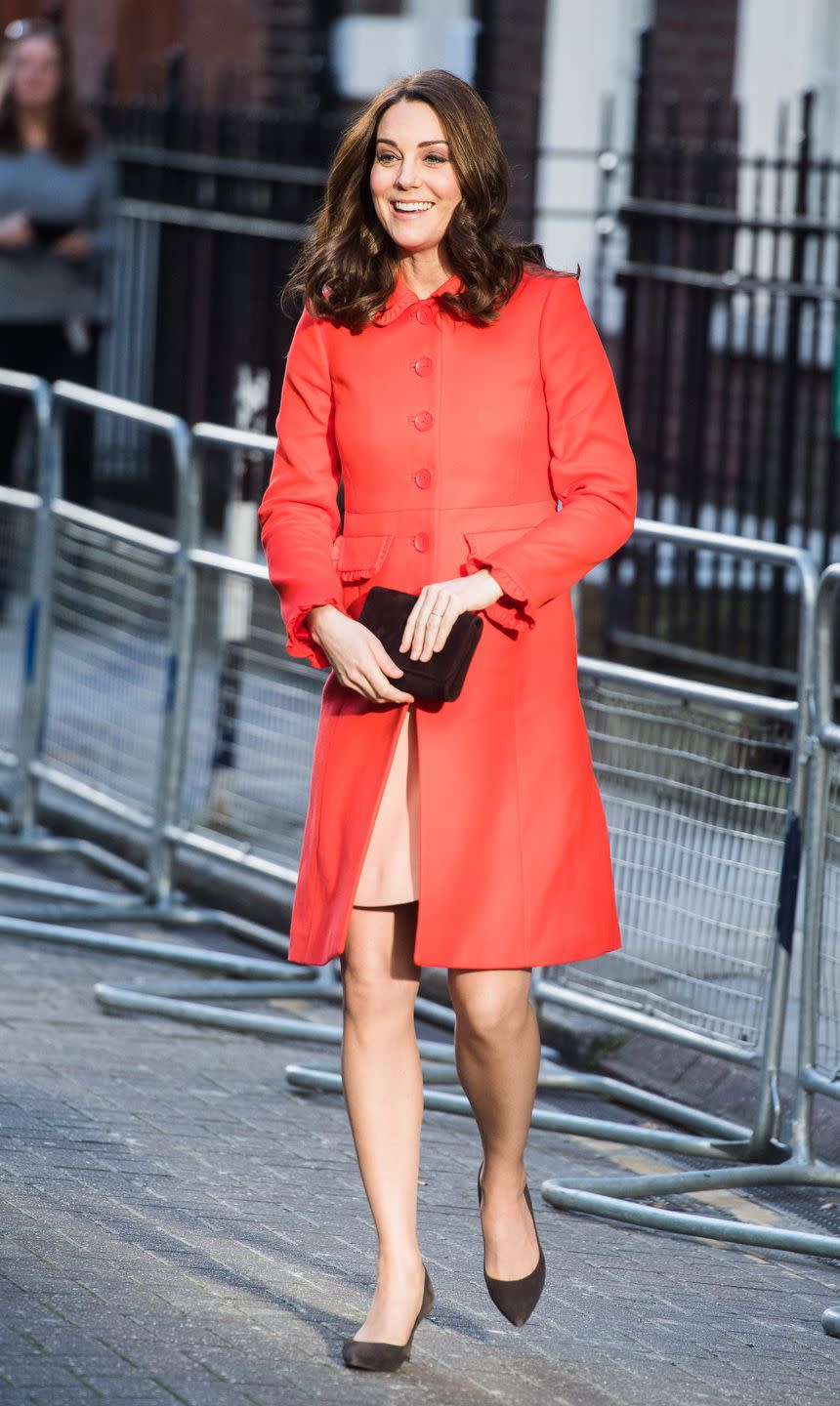 <p>In a red ruffled coat by Boden (her <a href="http://www.telegraph.co.uk/fashion/people/duchess-cambridge-wears-boden-first-time-else-should-buy-british/" rel="nofollow noopener" target="_blank" data-ylk="slk:first time;elm:context_link;itc:0;sec:content-canvas" class="link ">first time</a> wearing the British brand), a tan dress, a black clutch, and black pumps while visiting Great Ormond Street Hospital in London.</p>