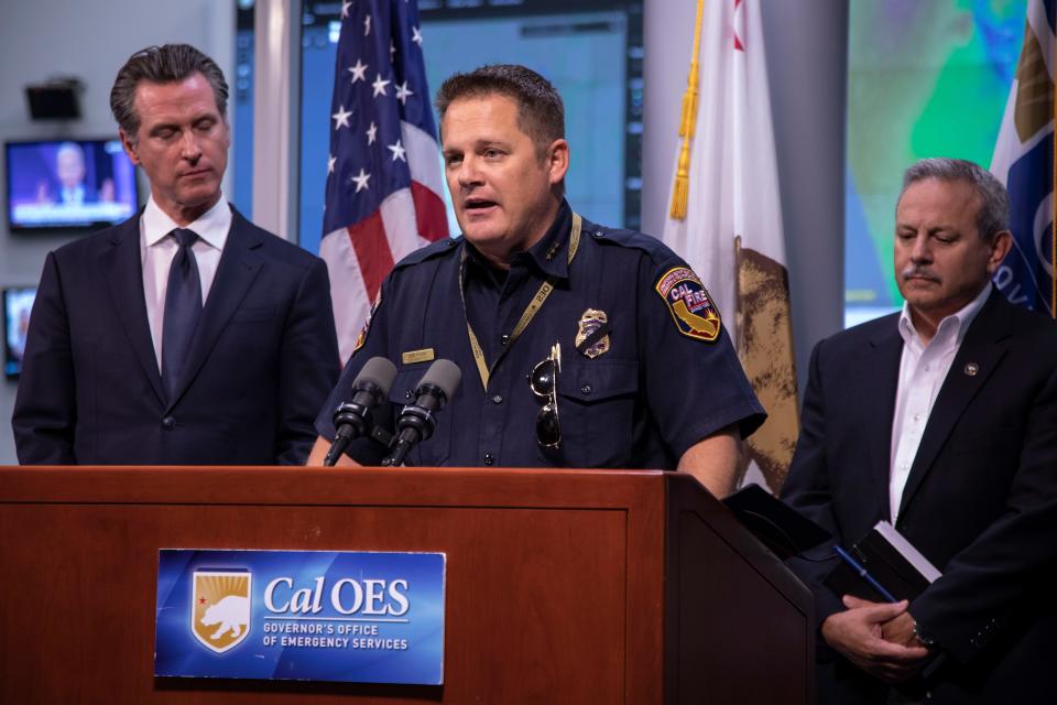 CalFire Chief Joe Tyler speaks to reporters at the Office of Emergency Services Command Center outside Sacramento, Calif. about PG&E power outages and fires burning across the state