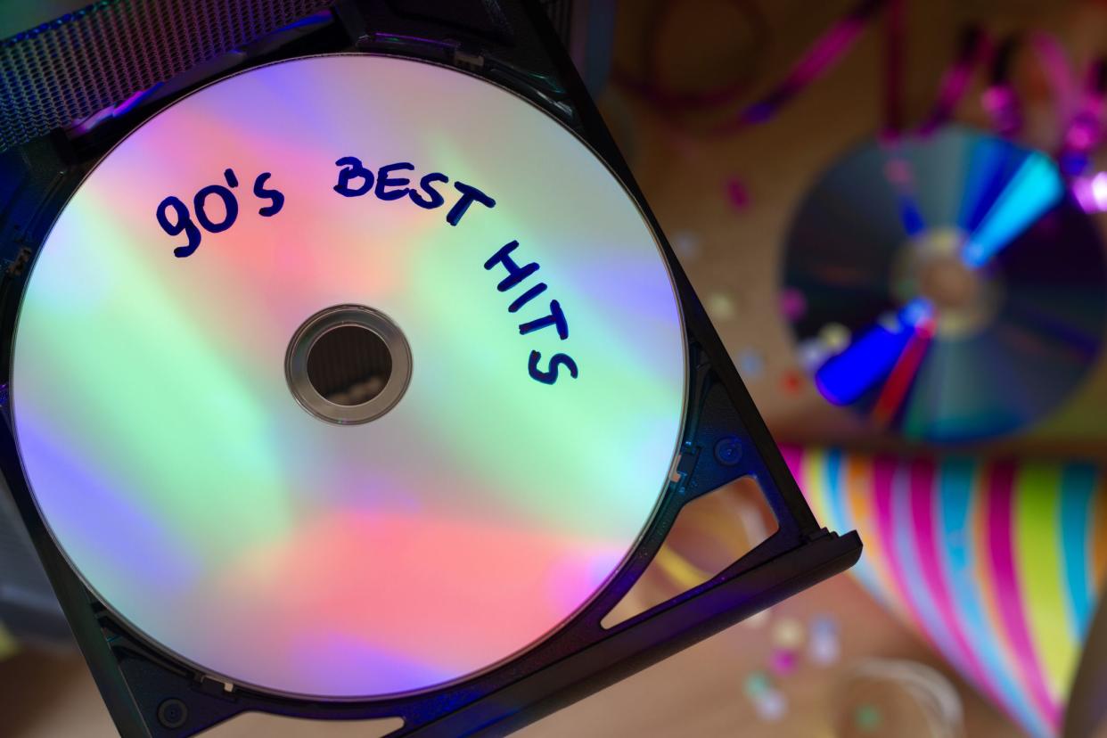 CD with music from 90s, disco party lights, party concept to 90s music idea