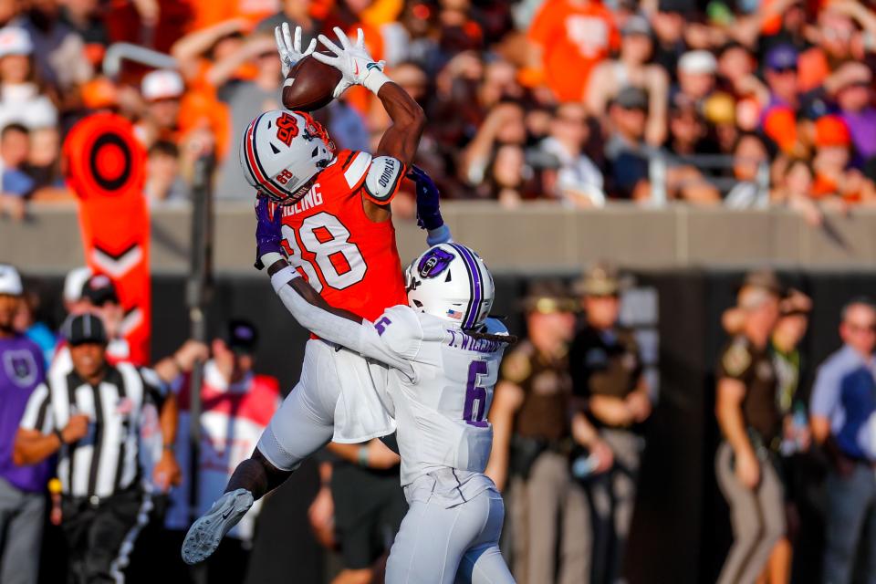 Sep 2, 2023; Stillwater, Oklahoma, USA; Oklahoma State's De'Zhaun Stribling (88) jumps for a catch for a first down and is brought down by Central Arkansas's T.D. Williams (6) in the first quarter during an NCAA football game between Oklahoma State and Central Arkansas at Boone Pickens Stadium. Mandatory Credit: Nathan J. Fish-USA TODAY Sports