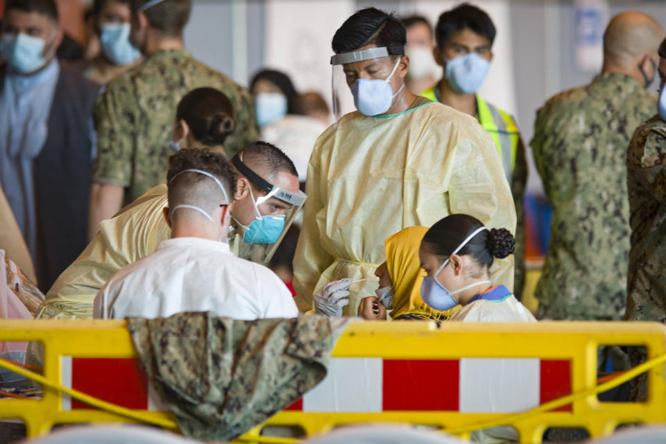 One of the evacuees from Afghanistan undergoes a COVID test after disembarking from a U.S. airforce plane at the Naval Station in Rota, southern Spain, Tuesday Aug. 31, 2021. The United States completed its withdrawal from Afghanistan late Monday, ending America's longest war. (AP Photo/ Marcos Moreno)