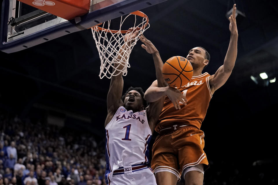 Texas forward Dylan Disu, right, knocks the ball away from Kansas guard Joseph Yesufu (1) during the first half of an NCAA college basketball game Monday, Feb. 6, 2023, in Lawrence, Kan. (AP Photo/Charlie Riedel)