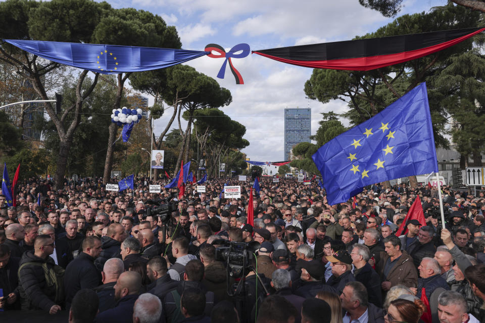 People take part in an an anti-government protest held near a summit of European Union leaders and their counterparts from the Western Balkans in the capital Tirana, Albania , on Tuesday, Dec. 6, 2022. Sali Berisha, a 78-year-old former president, prime minister and the leader of the Albanian opposition center-right Democratic Party has been attacked during protest when a man came out of the crowd and punched him in the face. The opposition was protesting against alleged corruption by Prime Minister Edi Rama, which they blame for the country's cost-of-living crisis.(AP Photo/Franc Zhurda)