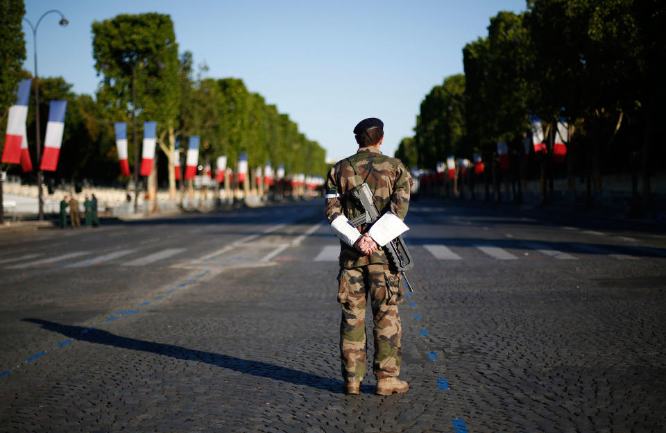 A French soldier waits on the Champs Elysees