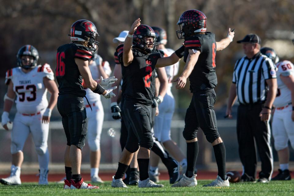 Rossville Corey Catron (2) and Torrey Horak (6) celebrate during the final moments of the game Saturday in Salina.