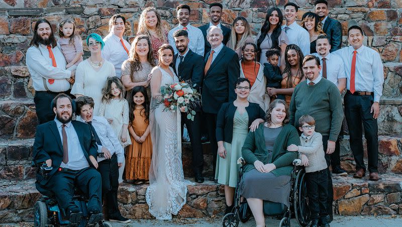 Greg Richardson poses with 15 of his children, their spouses and grandchildren at his daughter’s wedding in October 2021. Four of Greg’s children and two of his grandchildren are not in the photo.