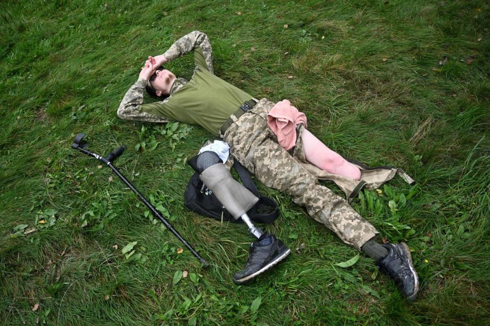 Ukrainian serviceman Andriy, 20, with an amputated leg, rests after climbing Mount Kliuch, 927-meters-high, near the village of Trukhaniv, Lviv Oblast, on Sept. 16, 2023. (Yuriy Dyachyshyn/AFP via Getty Images)