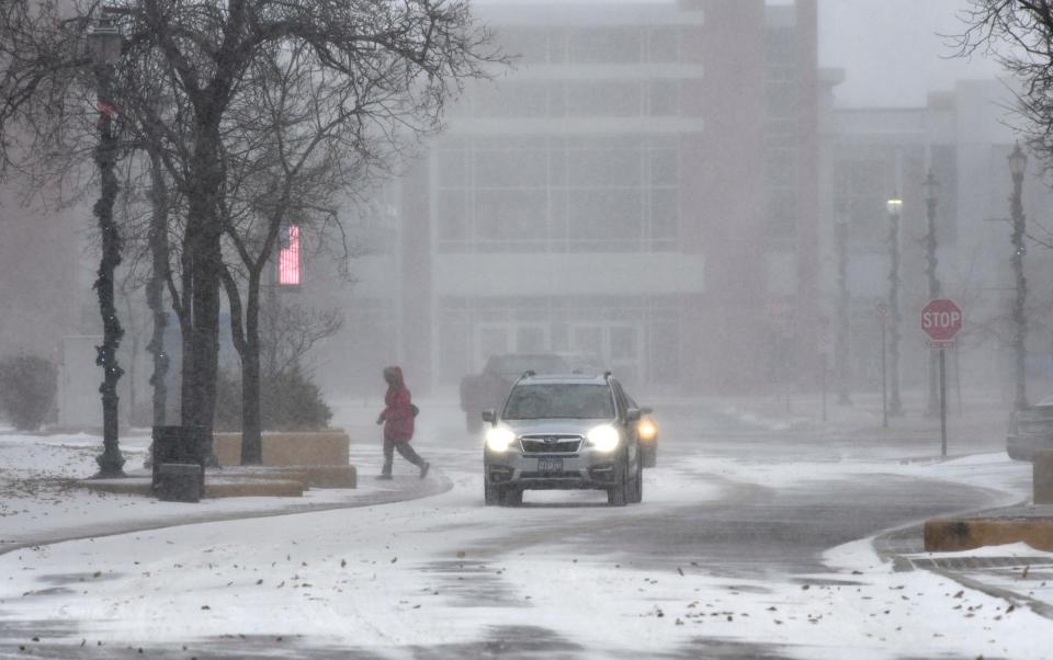 Heavy snow reduces visibility on St. Germain Street Wednesday, Dec. 23, 2020, in downtown St. Cloud.  