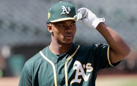 Oakland Athletics draft pick Kyler Murray looks on before a baseball game between the Athletics and the Los Angeles Angels, in Oakland, Calif. Murray's locker remained empty on Monday, Feb. 11, 2019, in the spring training clubhouse of the Oakland Athletics, who say they are uncertain when or if the Heisman Trophy winner will report to the baseball team he signed with last summer - Credit: AP
