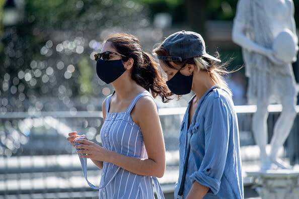 Park visitors wear masks in Washington Square Park during the third phase of the coronavirus reopening in New York.