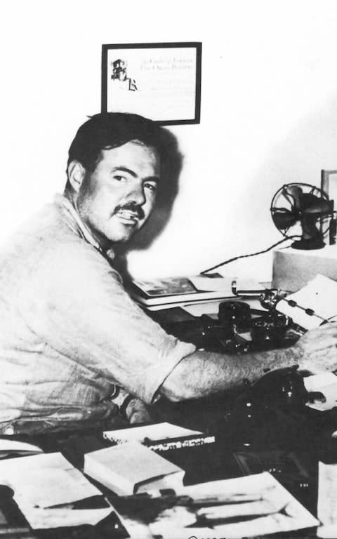 Hemingway at work in Key West, Florida - Credit: Granger/REX/Shutterstock