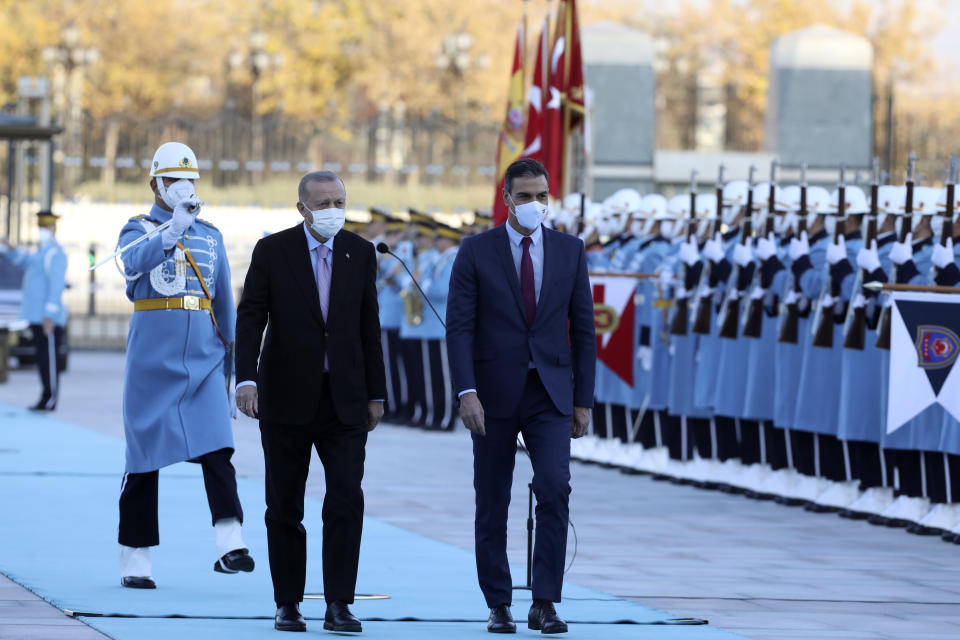 Turkey's President Recep Tayyip Erdogan, left, and Spanish Prime Minister Pedro Sanchez review a military honour guard during a welcoming ceremony at the presidential palace, in Ankara, Turkey, Wednesday, Nov. 17, 2021. (AP Photo/Burhan Ozbilici)