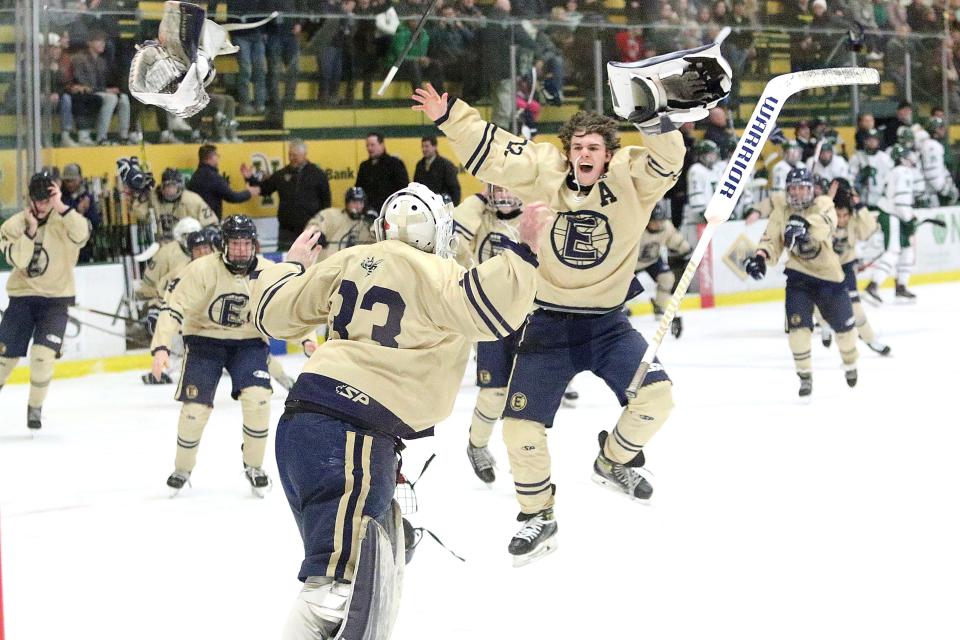 Essex goalie Ian Boutin throws his gear into the air as Ben Peake runs towards him after their 2-0 win over Rice in the D1 state title game on Wednesday night at UVM's Gutterson Fieldhouse.