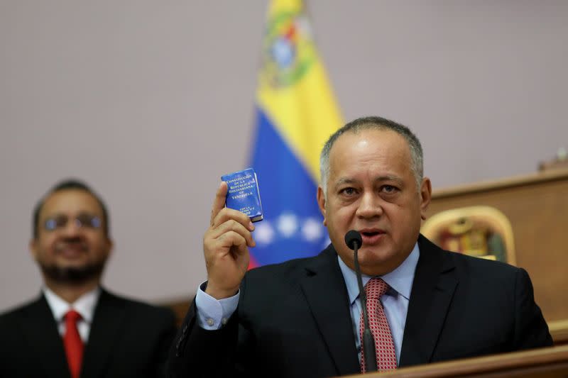 Venezuela's National Constituent Assembly President Diosdado Cabello holds Venezuela's constitution during a news conference in Caracas