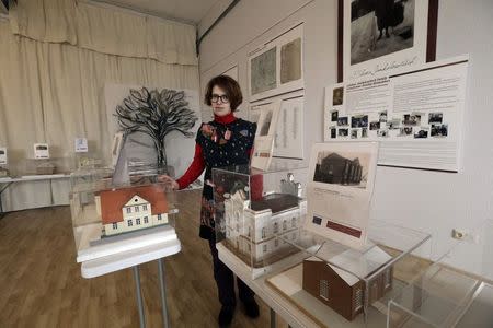 Ghetto museum executive director Victoria Shaldova poses near synagogue models in Riga February 27, 2015. REUTERS/Ints Kalnins