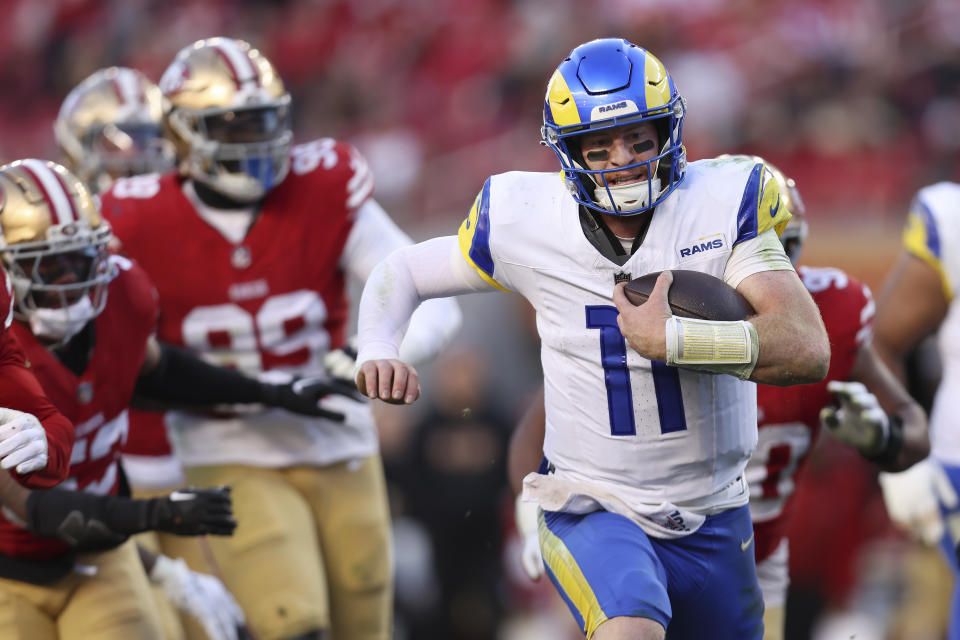 Los Angeles Rams quarterback Carson Wentz (11) runs for a touchdown against the San Francisco 49ers during the second half of an NFL football game in Santa Clara, Calif., Sunday, Jan. 7, 2024. (AP Photo/Jed Jacobsohn)