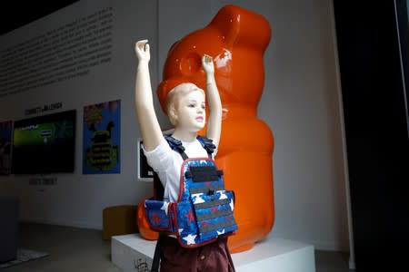 A child mannequin is seen wearing a bullet proof vest as part of an art installation by artist WhIsBe titled "Back to School Shopping" to illustrate the dangers of gun violence in schools, at a gallery in New York City