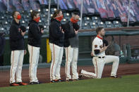 San Francisco Giants' Austin Slater, right, kneels during the national anthem before a baseball game between the Giants and the Colorado Rockies in San Francisco, Tuesday, Sept. 22, 2020. (AP Photo/Jeff Chiu)