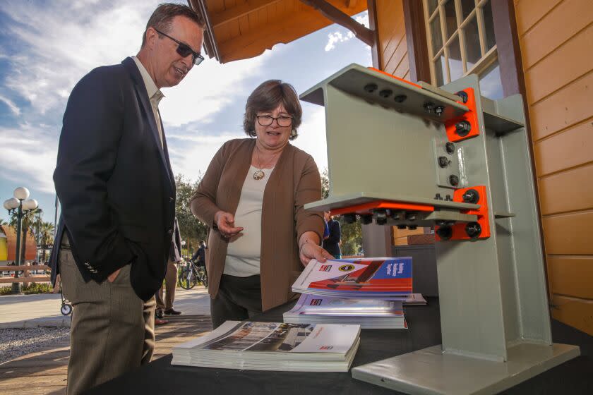 North Hollywood, CA - October 20: Jeff Ellis, left, director of codes and compliance, left, talks to Seismologist Dr. Lucy Jones, co-creator of the Great ShakeOut, about earthquake retrofitting material produced by his company Simpson Strong-Tie, at press conference held at Historic North Hollywood Train Depot on Thursday, Oct. 20, 2022 in North Hollywood, CA. (Irfan Khan / Los Angeles Times)